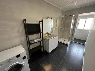 a bathroom with a sink and a washing machine at 5 minuts Ruzzafa, perfect locatión 6PX & Wifi in Valencia