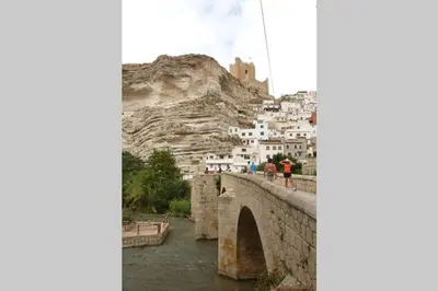 a bridge over a river in front of a mountain at Anna, embrujo de la naturaleza in Anna