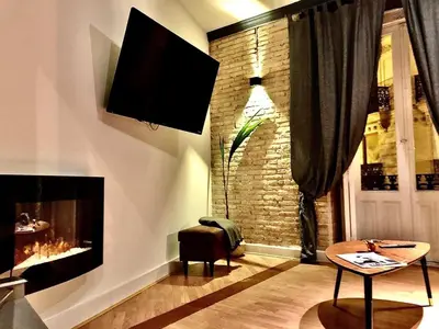 a living room with a tv and a fireplace at València Experience Apartment in Valencia