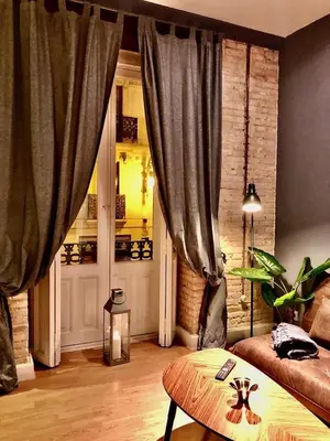 a living room with a couch and a table at València Experience Apartment in Valencia