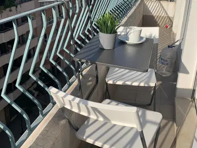 a table and chairs sitting on a balcony at PRECIOSO APARTAMENTO EN EL BARRIO DE RUZAFA in Valencia
