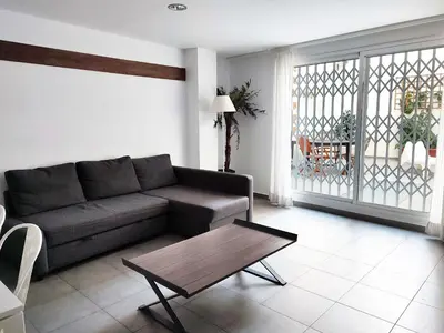 a living room with a couch and a coffee table at Flats Friends Tetuan in Valencia
