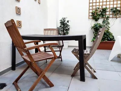 a black table and two chairs sitting at a table at Flats Friends Tetuan in Valencia