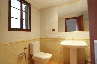a bathroom with a toilet and a sink at Global Vacacional, Adosado en la playa con piscina in Sagunto