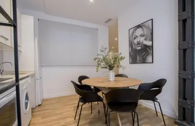 a dining room with a table and chairs at Apartamentos San Vicente in Valencia