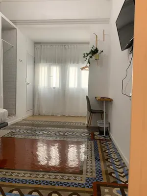 a living room with a window and a table at Star Home in Valencia