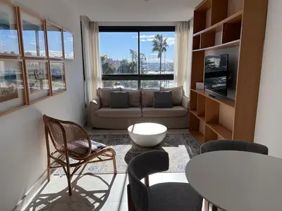 a living room with a couch and a table and chairs at Valencia Luxury - Calma Beach Apartments in Valencia