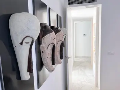 a room with a bunch of artifacts hanging on a wall at Valencia Luxury - Calma Beach Apartments in Valencia