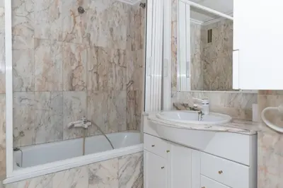 a bathroom with a tub and a sink and a bath tub at Florazar 3, 8º-B in Cullera