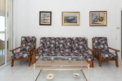 a living room with a couch and two chairs at Florazar 3, 8º-B in Cullera