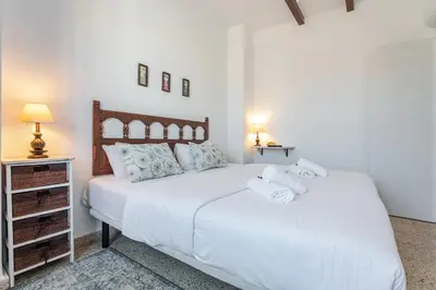 a bedroom with two beds with towels on them at Hostal El Perelló, Valencia in El Perelló