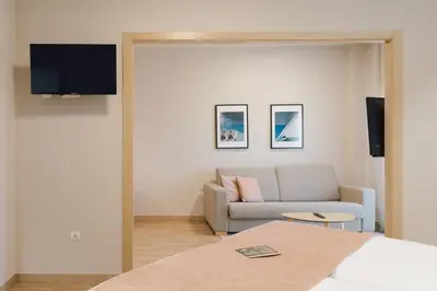 a living room with a couch and a television at Palau Suites & Apartments in Valencia