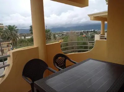a table and chairs on a balcony with a view at Bitacora II solo Familias Serviplaya in Casas Las Basas