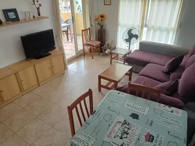 a living room with a couch and a table at Bitacora II solo Familias Serviplaya in Casas Las Basas