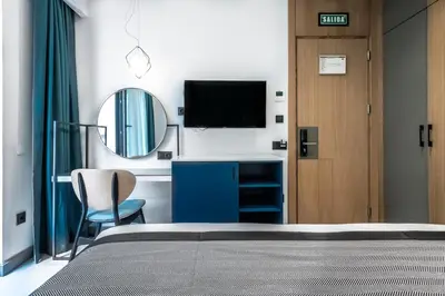 a bedroom with a bed and a mirror and a television at PAMPHYLIA HOTEL in Valencia
