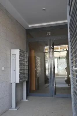 an entrance to a building with a sign in front at Natura Apartments in Chelva
