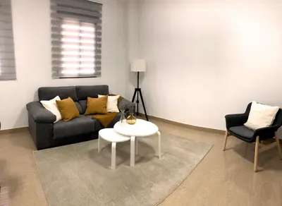 a living room with a couch and a table at Natura Apartments in Chelva