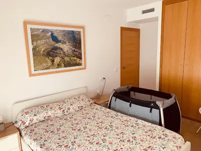 a bedroom with a bed and a painting on the wall at Casa del Herrero in Chulilla