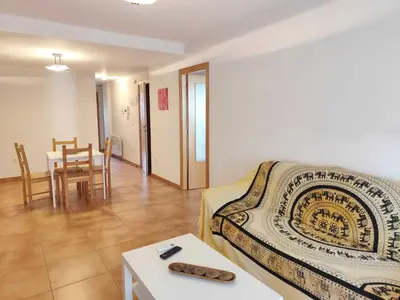 a living room with a bed and a table and a dining room at Caudiel entre Sierras in Caudiel