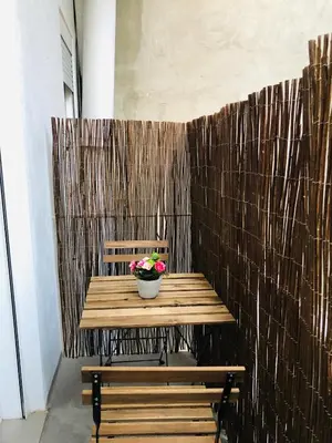 a wooden bench with a pot of flowers on it at Kasa Katia Guest House in Valencia