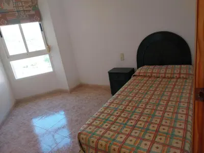 a bedroom with a bed and a window at Parquemar I Solo Familias Serviplaya in Casas Las Basas