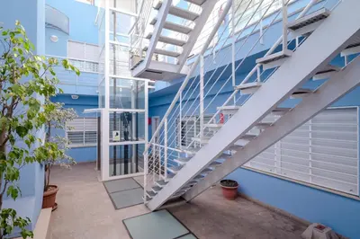 a staircase in a building with blue walls at Bet Apartments - Sunrise Beach Apartments in Valencia