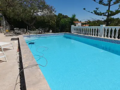 a swimming pool with blue water in a yard at Casa Loro Loco B&B in Pedralba