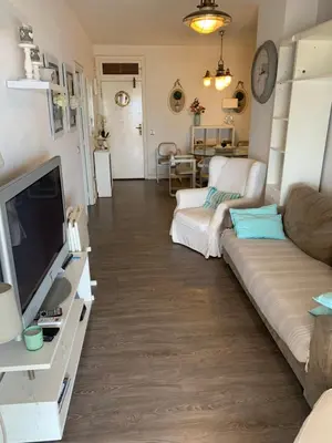 a living room with a couch and a tv at Apartamento primera línea de playa in Port Saplaya