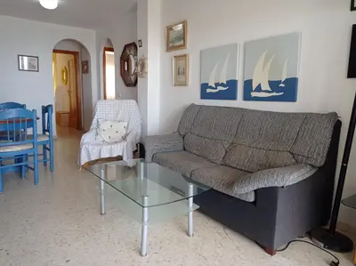 a bedroom with a window with yellow curtains at Mar Azul Solo Familias Serviplaya in Casas Las Basas