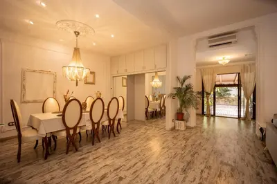 a dining room and living room with a table and chairs at Portrait Boutique Guesthouse in Valencia