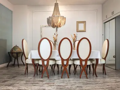 a dining room with a table with chairs and a chandelier at Portrait Boutique Guesthouse in Valencia