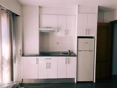 a kitchen with white cabinets and a refrigerator at Ayuntamiento Silence in Valencia