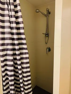 a shower with a black and white curtain in a bathroom at Ayuntamiento Silence in Valencia
