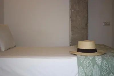 a hat is sitting on top of a bed at New Room in the beach in Valencia