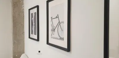 two framed pictures of a bike on a wall at New Room in the beach in Valencia
