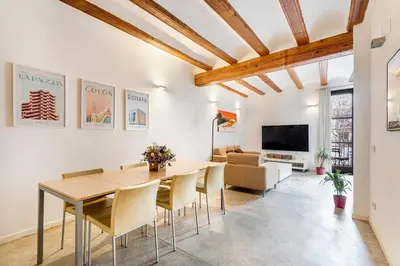 a dining room with a table and chairs and a couch at Loft Mercado Mossen Sorell in Valencia