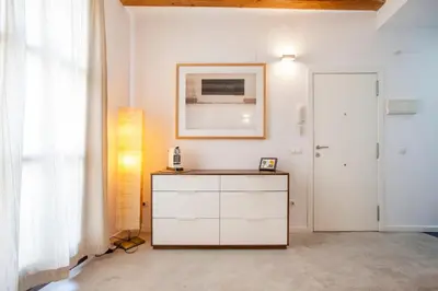 a white room with a dresser and a door at Loft Mercado Mossen Sorell in Valencia