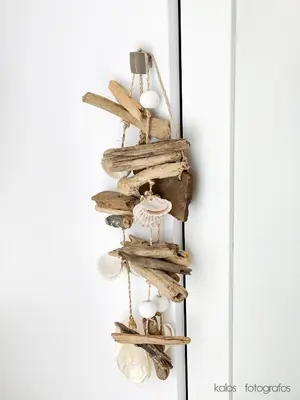 a driftwood christmas ornament hanging on a wall at Increible ático con vistas al Mediterraneo by Hometels in Puerto de Sagunto