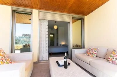 a living room with a couch and a table at Big Terrace Apartment Cullera in Cullera