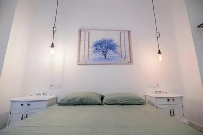 a bedroom with a bed and two white tables at Cozy Flat in City Center Feel the Vibe SelfCheckIn in Valencia