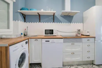 a kitchen with a washing machine and a washer at Cozy Flat in City Center Feel the Vibe SelfCheckIn in Valencia
