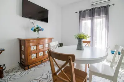 a white dining room with a white table and chairs at Cozy Flat in City Center Feel the Vibe SelfCheckIn in Valencia