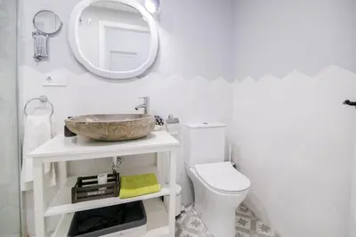 a bathroom with a sink and a toilet and a mirror at Cozy Flat in City Center Feel the Vibe SelfCheckIn in Valencia