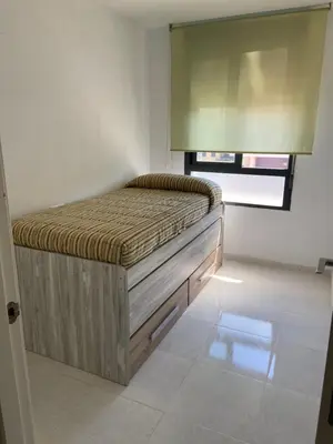 a bedroom with a bed in the corner of a room at Atico playa Moncofar in Moncófar
