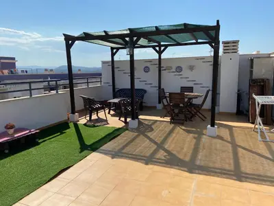 a patio with tables and chairs on a roof at Atico playa Moncofar in Moncófar
