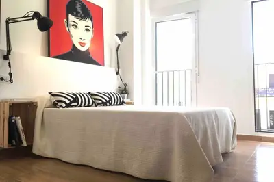 a bedroom with a bed with a painting on the wall at Casa La Placeta in Fortaleny