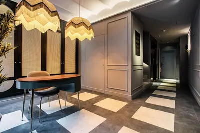 a lobby with a table and chairs in a building at Reina 107 Beach Boutique in Valencia