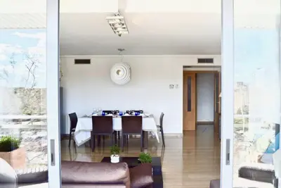 a dining room with a table and a room with a table at Art and Sciences view luxury apartment in Valencia