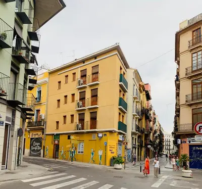 a group of people walking down a city street at 123rooms in Valencia