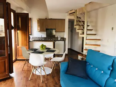 a living room with a blue couch and a table at 123rooms in Valencia